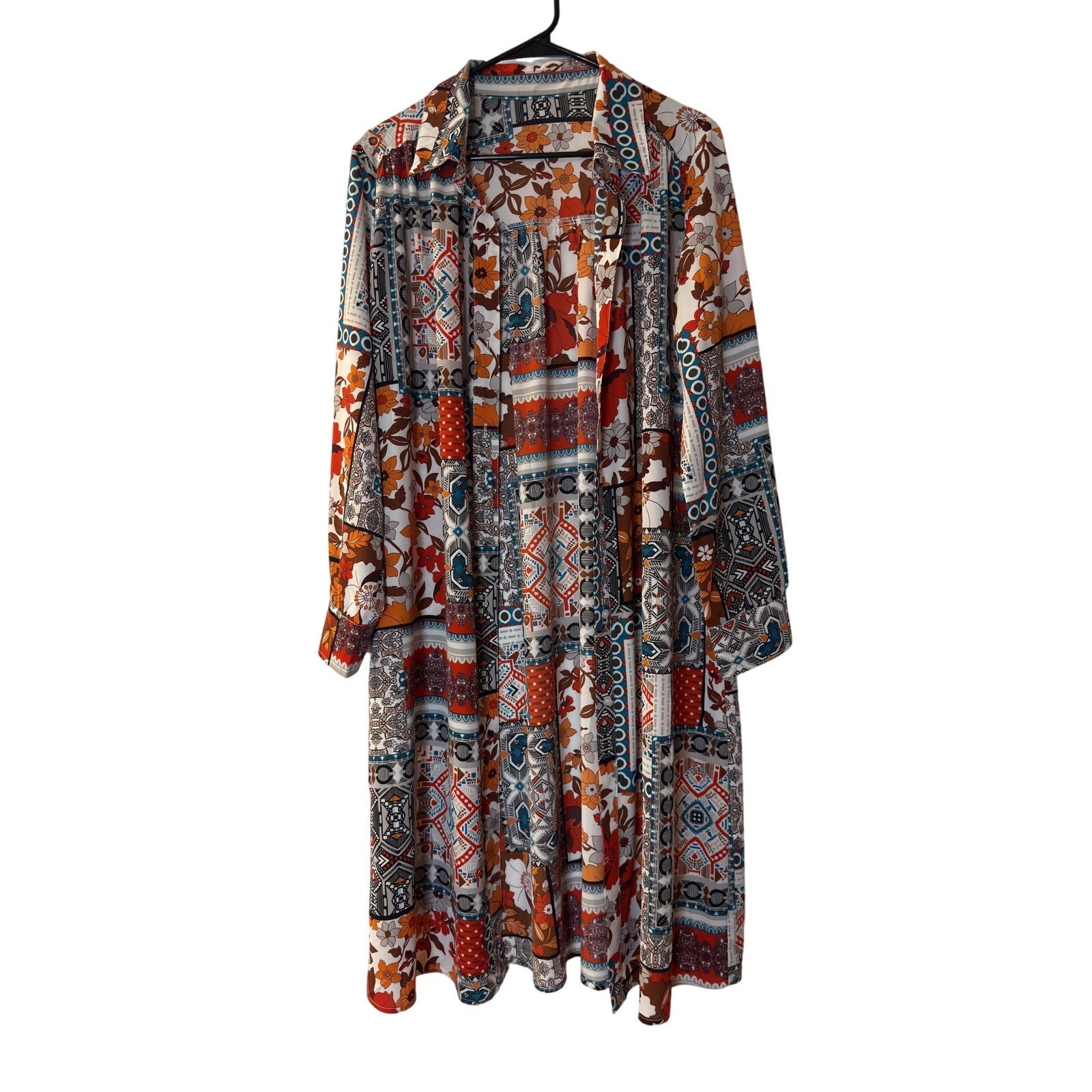 This is a bohemian-style floral geometric orange and tan button-down shirt dress or long cardigan