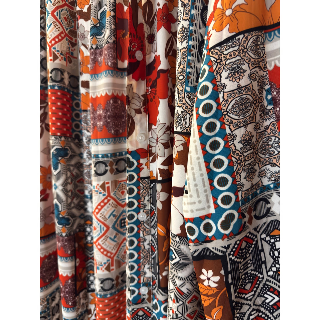 This is a bohemian-style floral geometric orange and tan button-down shirt dress or long cardigan