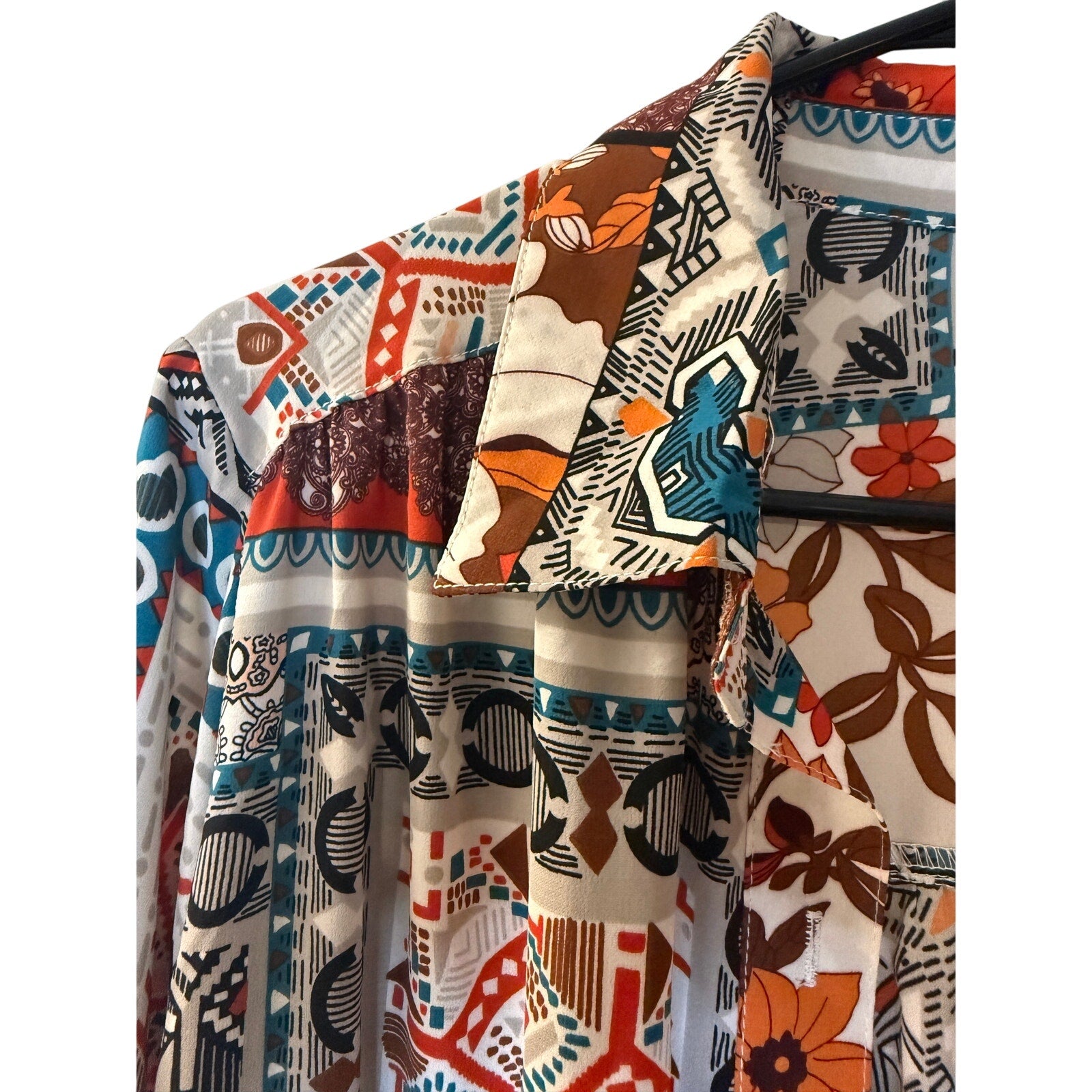 This is a bohemian-style floral geometric orange and tan button-down shirt dress or long cardigan