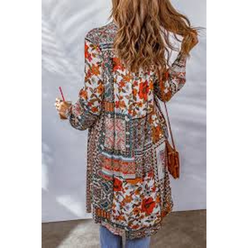 This is a bohemian-style floral geometric orange and tan button-down shirt dress or long cardigan